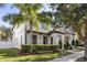 Two-story house with white siding, palm trees, and manicured hedges at 11560 Ashlin Park Blvd, Windermere, FL 34786