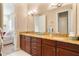 Double vanity bathroom with granite countertops and wood cabinets at 11748 Waterstone Loop Dr, Windermere, FL 34786