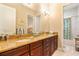 Double vanity bathroom with granite countertops and wood cabinets at 11748 Waterstone Loop Dr, Windermere, FL 34786