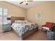 Spacious bedroom with wood bed frame, nightstand and chair at 11748 Waterstone Loop Dr, Windermere, FL 34786