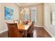 Elegant dining room featuring hardwood floors, large windows and a beautiful chandelier at 11748 Waterstone Loop Dr, Windermere, FL 34786