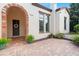 Elegant entryway with a brick arch, dark wooden door, and terracotta tile flooring at 11748 Waterstone Loop Dr, Windermere, FL 34786