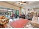 Bright living room with hardwood floors, fireplace, and view of the pool and patio at 11748 Waterstone Loop Dr, Windermere, FL 34786