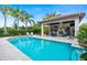 Resort-style pool and spa with outdoor kitchen and covered seating at 11748 Waterstone Loop Dr, Windermere, FL 34786