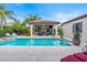 Inviting pool with a covered patio and outdoor kitchen at 11748 Waterstone Loop Dr, Windermere, FL 34786