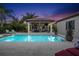 Stunning pool area at sunset with covered patio and fireplace at 11748 Waterstone Loop Dr, Windermere, FL 34786