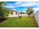 Large grassy backyard with a shed and privacy fence at 121 Whirlaway Dr, Davenport, FL 33837