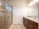 Bathroom with granite countertop, double sinks, and shower at 121 Whirlaway Dr, Davenport, FL 33837