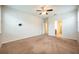 Spacious bedroom with neutral walls, ceiling fan, and carpeted floor at 121 Whirlaway Dr, Davenport, FL 33837