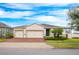 Attractive single-story home with three-car garage and landscaped front yard at 121 Whirlaway Dr, Davenport, FL 33837