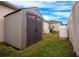 Tan and brown storage shed in backyard with propane tank at 121 Whirlaway Dr, Davenport, FL 33837