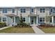 Two-story townhouses with light-grey siding, landscaping, and paved walkways at 12455 Shipwatch St, Orlando, FL 32832