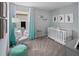 Bedroom with crib, chair, and teal accents at 12463 Shipwatch St, Orlando, FL 32832