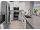 Modern kitchen with stainless steel appliances, gray countertops, and white cabinets at 12463 Shipwatch St, Orlando, FL 32832