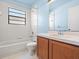 Clean bathroom with light blue walls and wood cabinets at 1360 Cherrybark Rd, Apopka, FL 32703