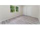 Well-lit bedroom featuring wood-look floors and double door closet at 1365 Indian Rock Ct, Deltona, FL 32725