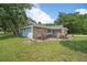 Single story home with stone exterior, and lush green lawn at 1365 Indian Rock Ct, Deltona, FL 32725