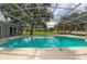 Inviting screened pool with ample deck space and backyard view at 1365 Indian Rock Ct, Deltona, FL 32725