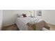 Bright bedroom features neutral walls and carpet, with a comfortable bed and bright yellow flowers at 13731 Bravante Aly, Windermere, FL 34786