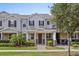 Charming two-story townhome with well-manicured landscaping, a covered front porch, and beautiful tree at 13731 Bravante Aly, Windermere, FL 34786