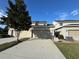 Townhouse exterior with a two-car garage and landscaping at 13731 Bravante Aly, Windermere, FL 34786