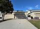 Townhouse exterior showcasing the garage and landscaping at 13731 Bravante Aly, Windermere, FL 34786