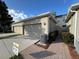 Townhouse exterior with a two-car garage and landscaping at 13731 Bravante Aly, Windermere, FL 34786