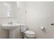 Neat half bathroom with pedestal sink, white toilet, and brushed nickel fixtures at 13731 Bravante Aly, Windermere, FL 34786