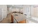 Open-concept kitchen with island featuring stainless steel sink and view to living area at 13731 Bravante Aly, Windermere, FL 34786