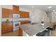 Well-equipped kitchen with granite countertops, stainless steel appliances and brown cabinets at 13731 Bravante Aly, Windermere, FL 34786