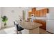 Well-equipped kitchen with granite countertops, stainless steel appliances, brown cabinets and breakfast bar at 13731 Bravante Aly, Windermere, FL 34786
