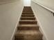 Carpeted staircase leading to the upper level of the home at 13731 Bravante Aly, Windermere, FL 34786