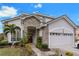 Two-story house with stone accents and a two-car garage at 1468 Patricia St, Kissimmee, FL 34744