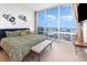 Large bedroom with city views and plush bedding at 150 E Robinson St # 2512, Orlando, FL 32801