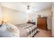 Comfortable bedroom with a dresser, desk, and plaid bedding at 1849 Dalton Dr, The Villages, FL 32162