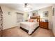 Cozy bedroom with a queen-size bed, wooden dresser, and plenty of natural light at 1849 Dalton Dr, The Villages, FL 32162