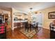 Kitchen dining area with brick accent wall and hardwood floors at 1849 Dalton Dr, The Villages, FL 32162