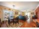 Bright dining room with hardwood floors and view into living room at 1849 Dalton Dr, The Villages, FL 32162