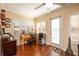 Bright home office features built-in shelving, wood flooring, and a view of the backyard at 1849 Dalton Dr, The Villages, FL 32162