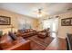 Spacious living room with leather furniture and hardwood floors at 1849 Dalton Dr, The Villages, FL 32162