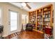 Home office with built-in bookcase and hardwood floors at 1849 Dalton Dr, The Villages, FL 32162