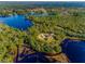 Aerial view showcasing house and surrounding lake at 1851 Grand Keahl Ln, Deltona, FL 32738