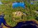 Aerial view of house nestled on a lake at 1851 Grand Keahl Ln, Deltona, FL 32738