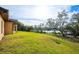 Landscaped backyard with a view of a lake and lush greenery at 1851 Grand Keahl Ln, Deltona, FL 32738