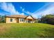 Expansive backyard featuring a covered patio area perfect for outdoor entertaining and enjoying the serene surroundings at 1851 Grand Keahl Ln, Deltona, FL 32738