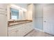 Elegant bathroom features a double vanity with granite countertops and custom cabinetry at 1851 Grand Keahl Ln, Deltona, FL 32738