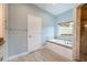 Bright bathroom showcasing a soaking tub with marble surround, walk-in shower and vanity at 1851 Grand Keahl Ln, Deltona, FL 32738