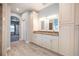 Bathroom with custom cabinets, double vanity, granite countertop, and tile flooring at 1851 Grand Keahl Ln, Deltona, FL 32738