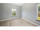 A simple bedroom with laminate flooring, a window, and neutral walls at 1851 Grand Keahl Ln, Deltona, FL 32738