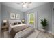 Cozy bedroom with a queen-sized bed, neutral tones, and a large window providing natural light at 1851 Grand Keahl Ln, Deltona, FL 32738